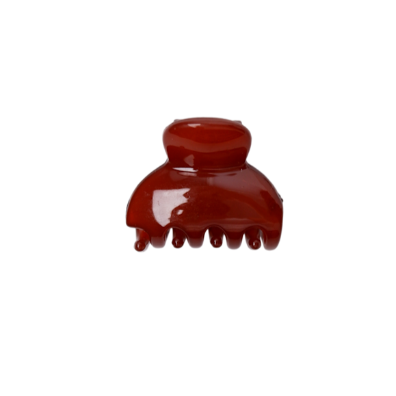 Red hair clip on a white background