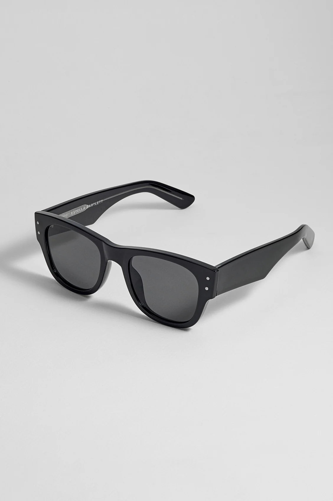 Black sunglasses on a light gray background