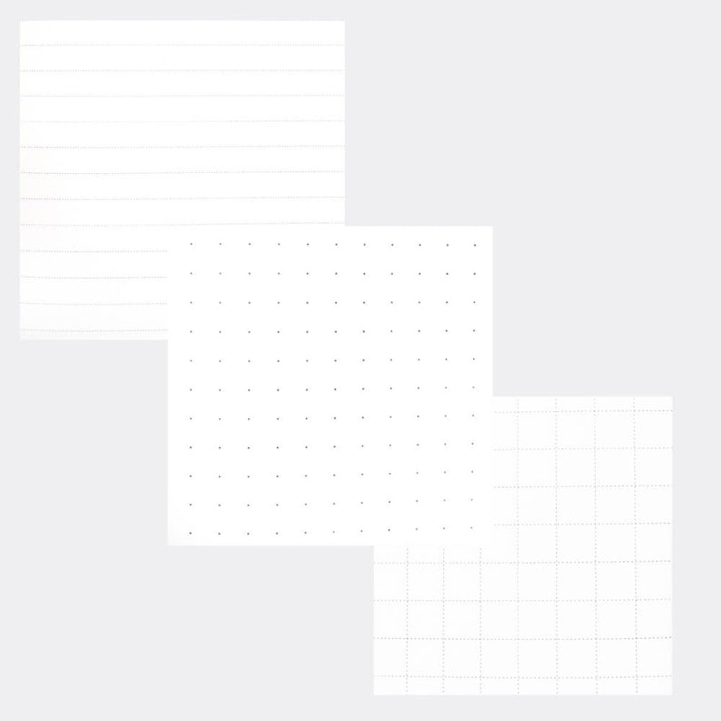 Three sheets of white paper with different grid patterns, including lined, dotted, and dashed grids, arranged on a light gray background.