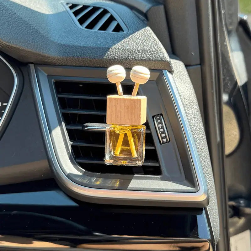 Car air freshener with a unique design on a car's air vent.