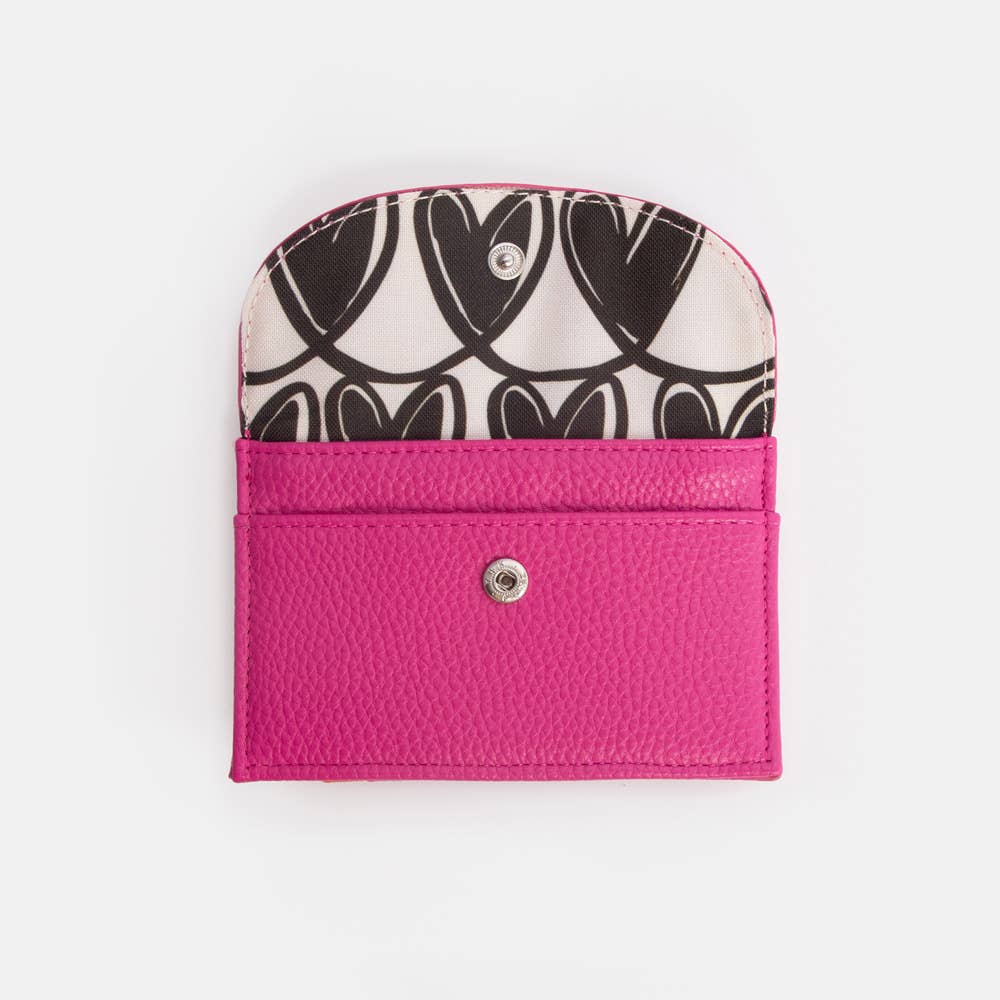Small pouch with black and white floral pattern on top and pink bottom on a white background