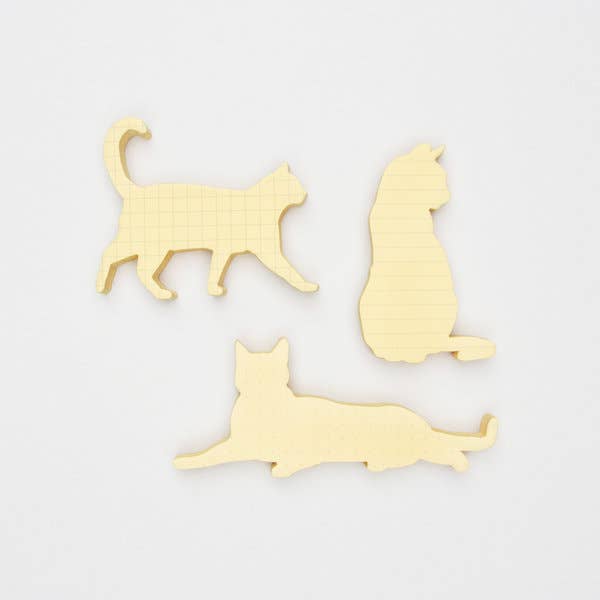 Three yellow cat-shaped coasters on a white background