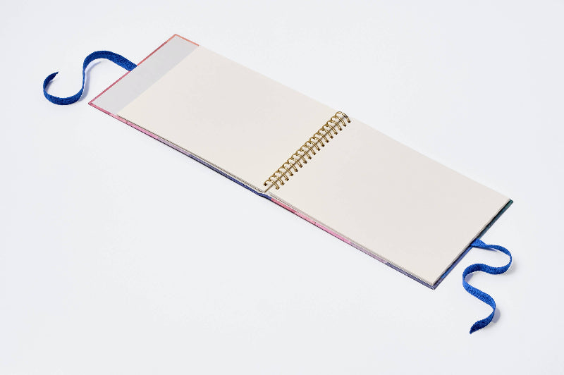 Open notebook with a spiral binding on a white background