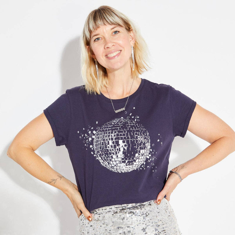 Woman wearing a purple t-shirt with a disco ball design on a white background