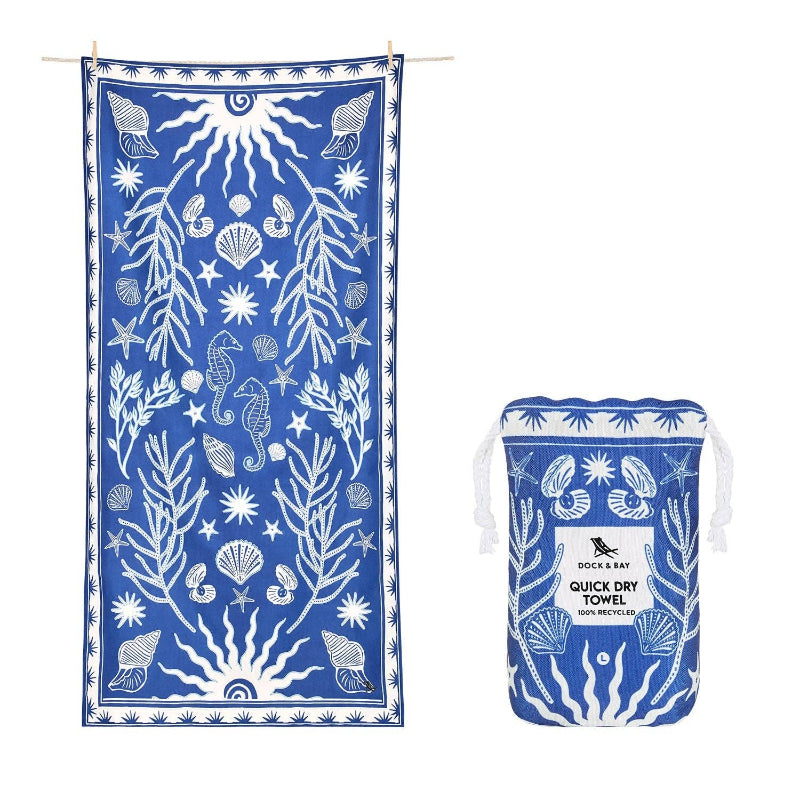 Blue towel with white sea-themed pattern and matching pouch on a white background