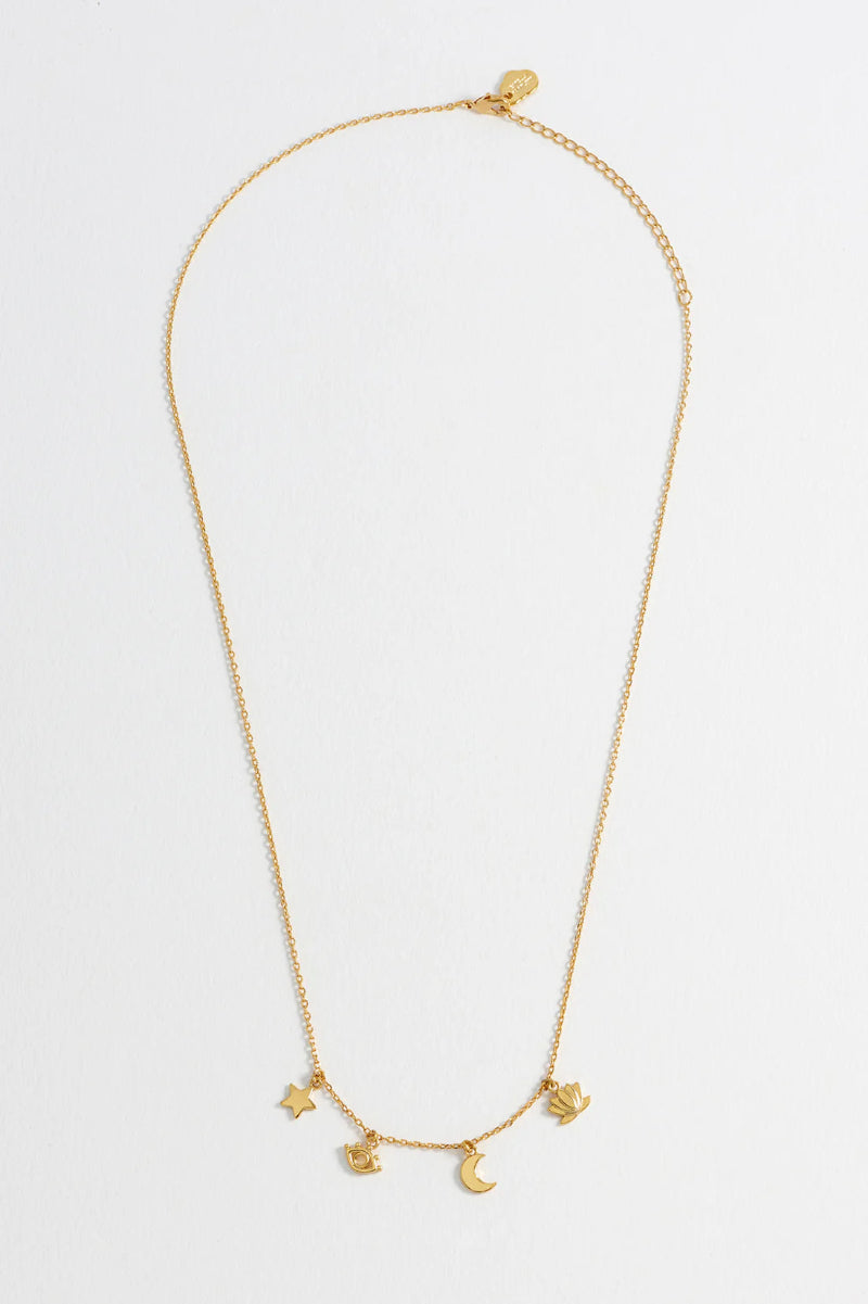 Gold necklace with star and moon charms on a white background