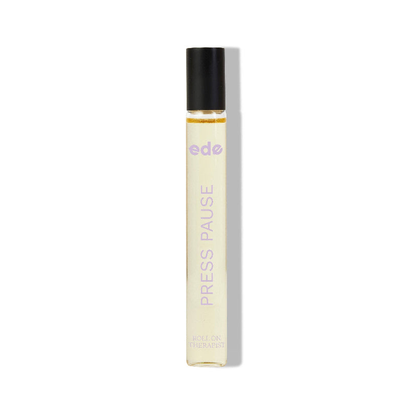 Small perfume bottle labeled 'Press Pause' with a black cap on a white background