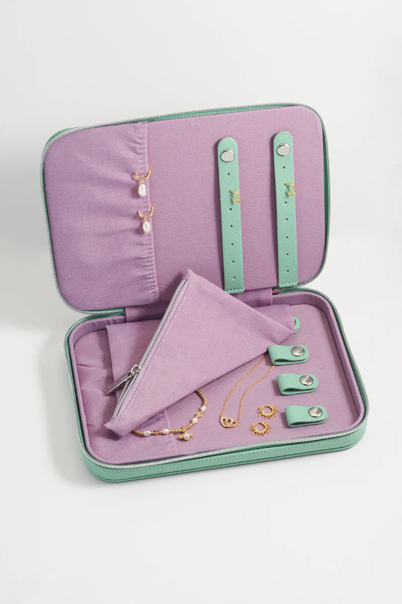 Open jewelry case with necklaces and accessories on a white background