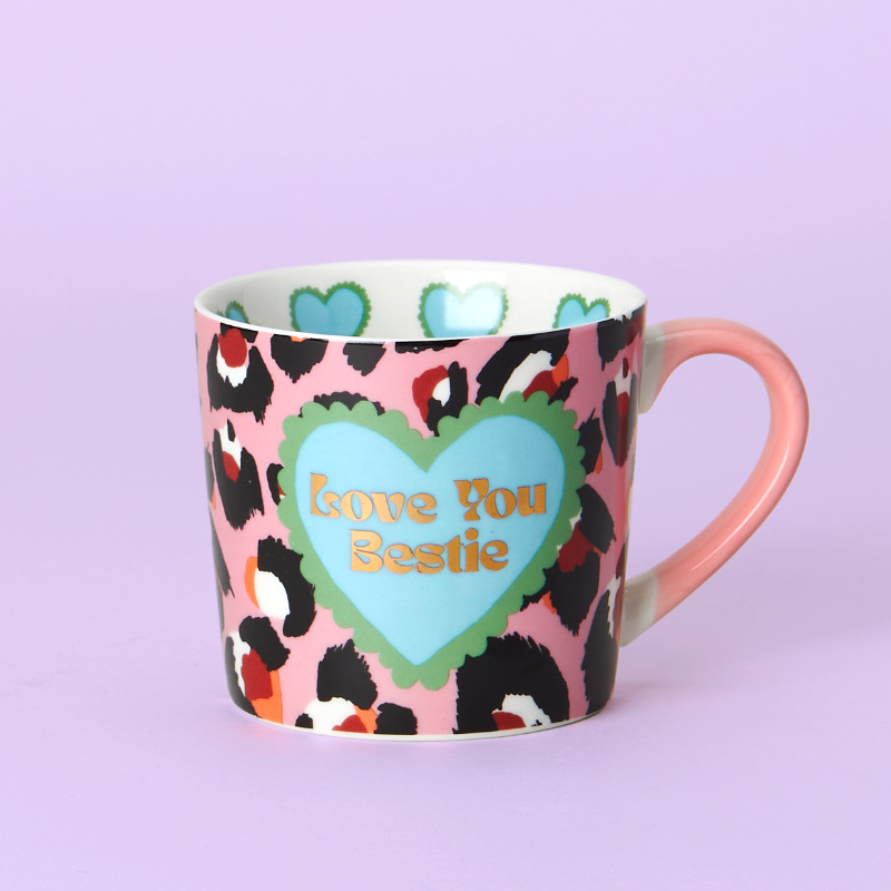 Mug with leopard print pattern and heart-shaped 'Love You Bestie' text on a purple background