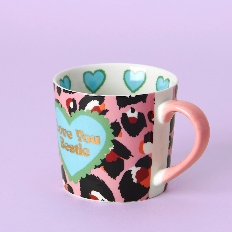Mug with leopard print and hearts design on a light purple background