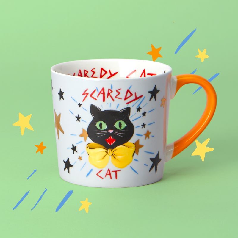 Mug with a black cat illustration and text on a green background