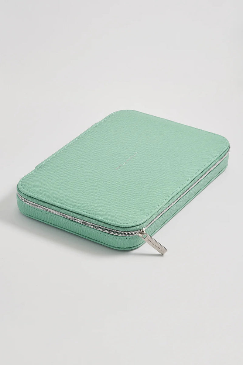 A mint green zippered pouch or organizer case with silver-toned metal zippers, photographed on a clean light gray studio background.