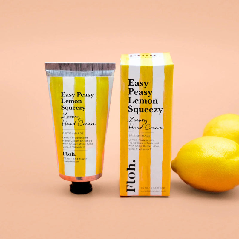 Hand cream and packaging with lemons on a peach background