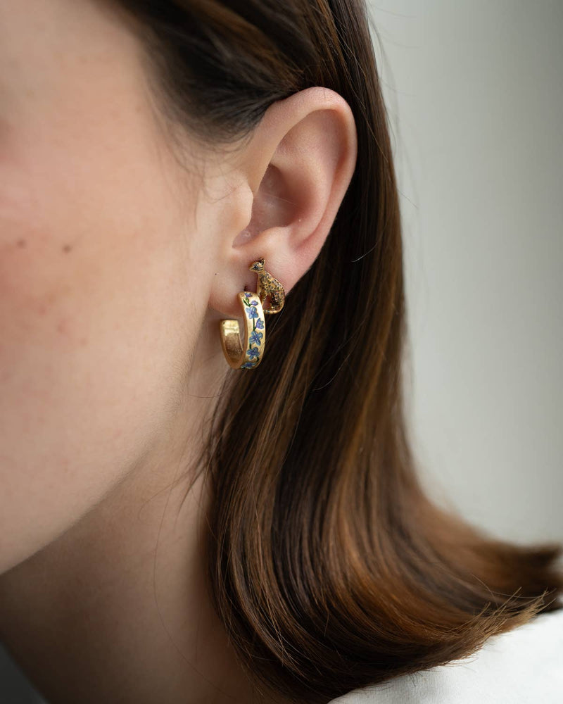 Close-up of a person wearing Fable Blue Forget-Me-Not Hoop Earrings