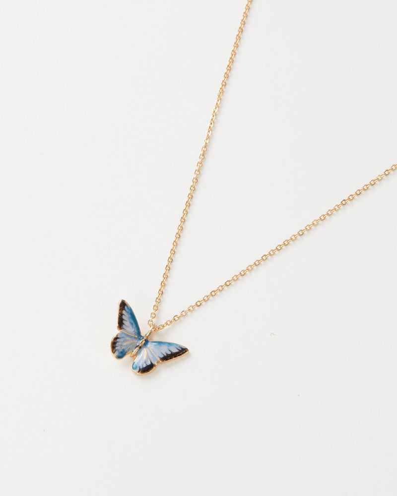 Butterfly pendant necklace on a gold chain against a white background