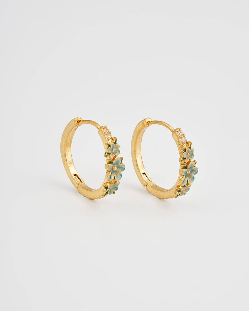 Gold hoop earrings with floral designs on a light grey background - Fable England