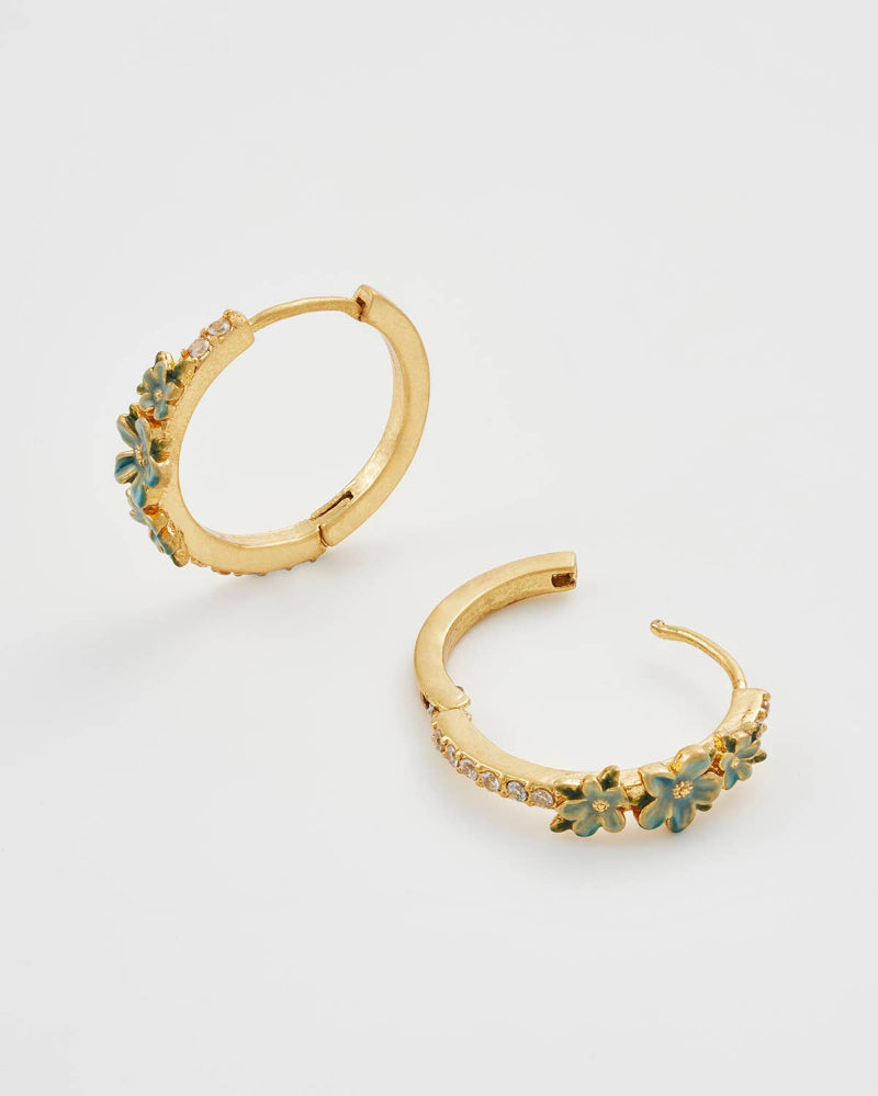 Fable England Gold hoop earrings with floral designs on a light gray background