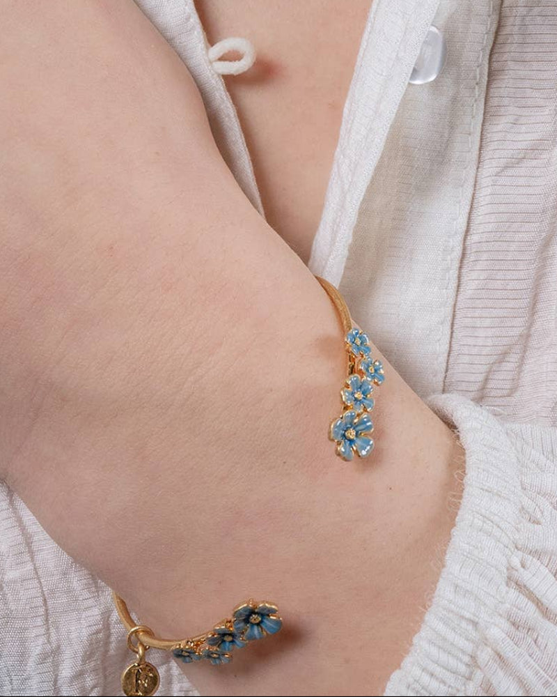 Fable Forget-Me-Not Bangle worn by a person in a white outfit.