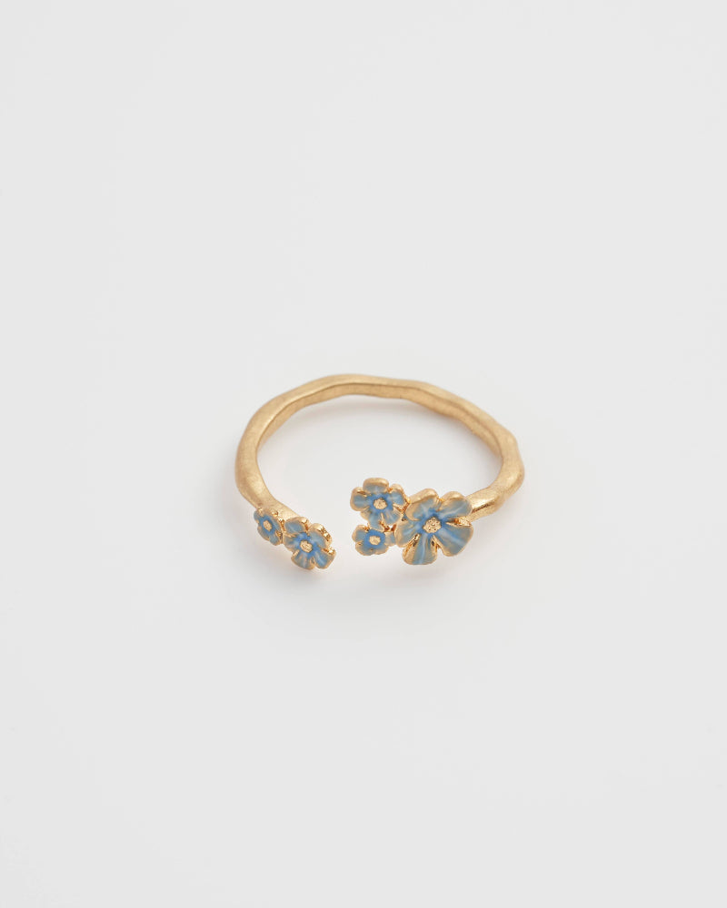 Fable England Gold ring with blue floral designs on a light gray background
