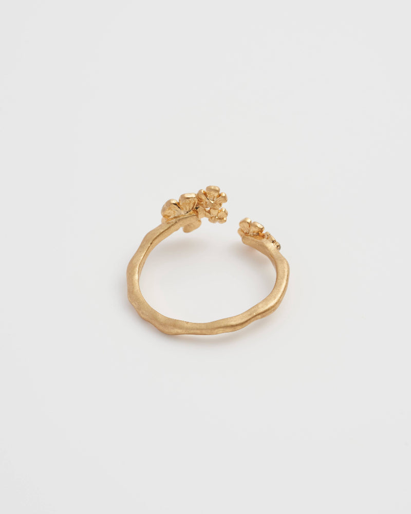 Fable Forget-Me-Not Ring Gold rwith floral design on a light grey background