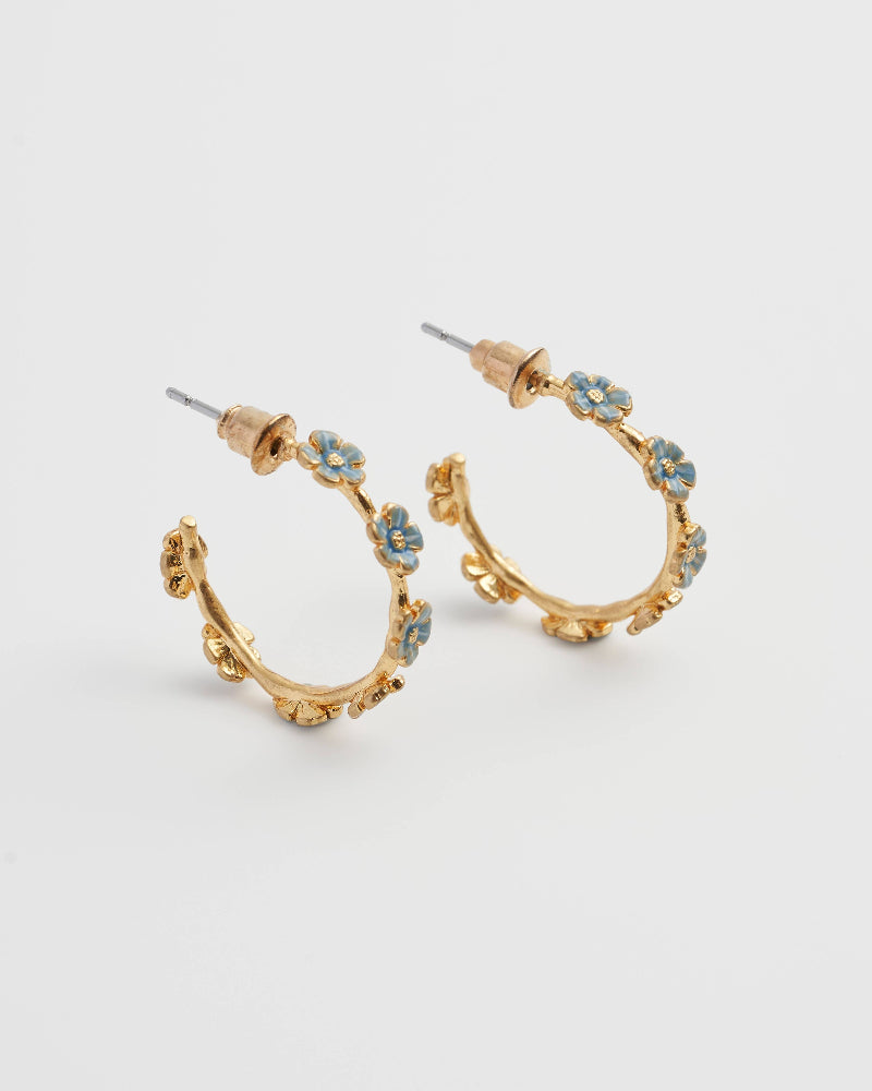Gold hoop Fable Forget-Me-Not Stud Hoops earrings with floral designs on a light grey background