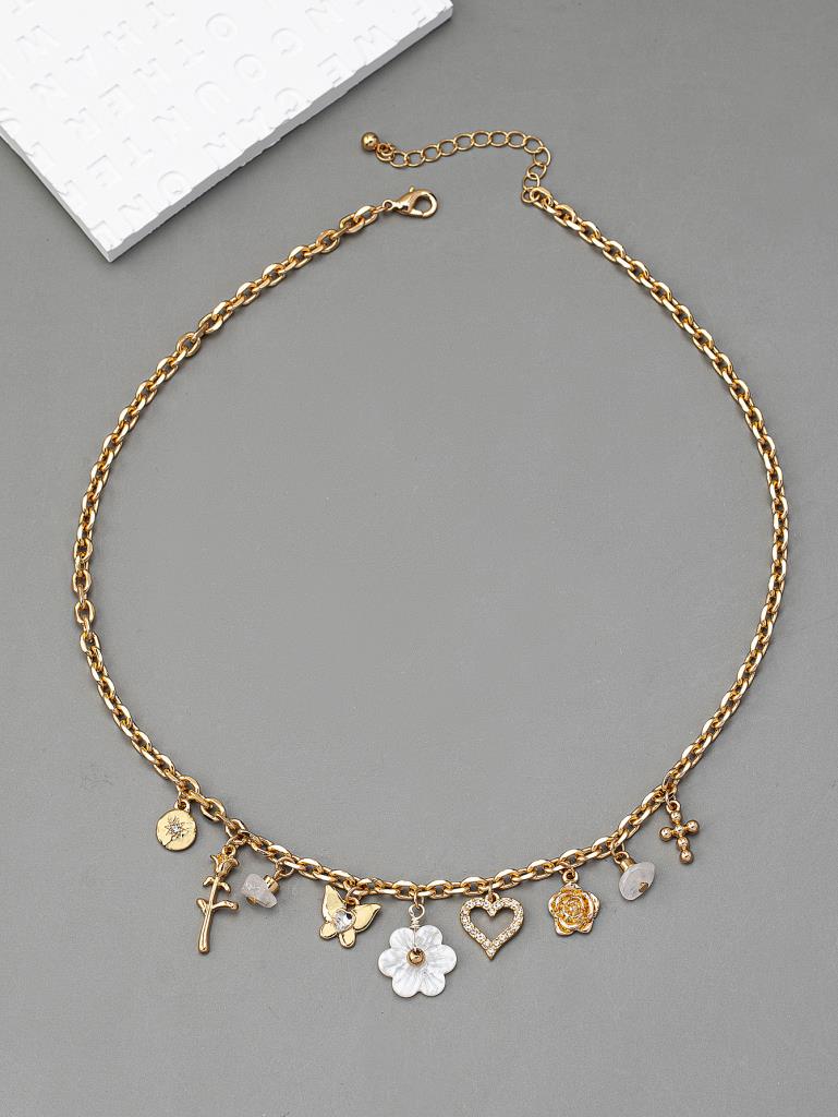 Gold necklace with various charms on a gray background