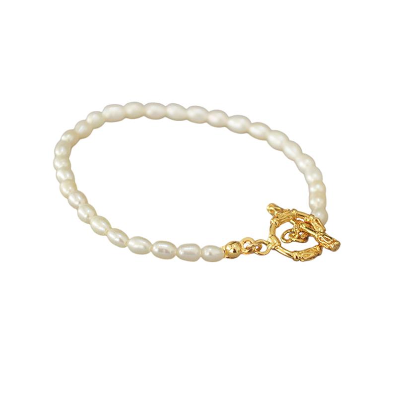 Pearl bracelet with a gold clasp on a white background