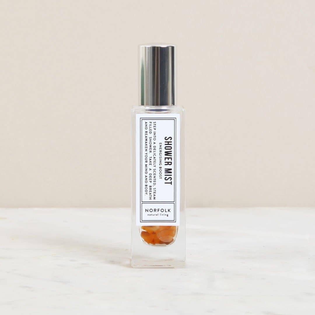 Shower mist bottle with a label on a light background