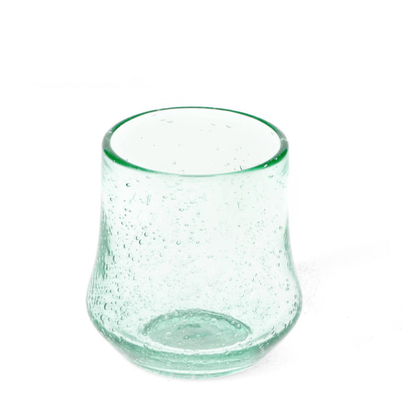 Clear glass tumbler with a textured surface on a white background