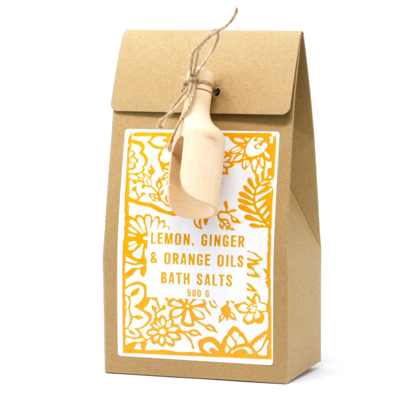 Kraft paper packaging of lemon, ginger, and orange oils bath salts with decorative label.