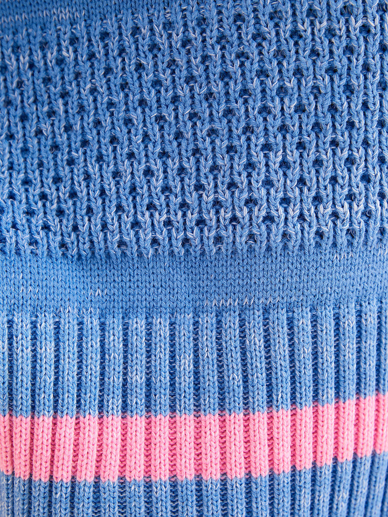 Close-up of blue fabric with a pink stripe and textured pattern