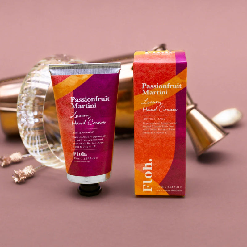 Passionfruit Martini hand cream with packaging on a pink background