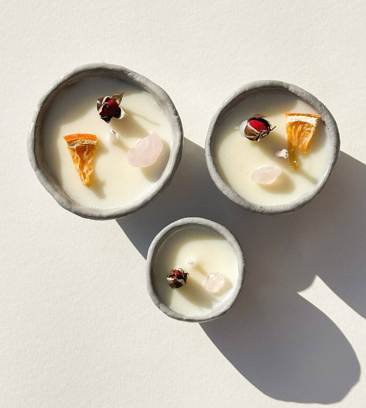 Three small bowls with a creamy texture and decorative elements on a light background