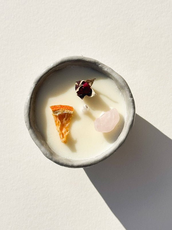Candle with decorative elements on a light background