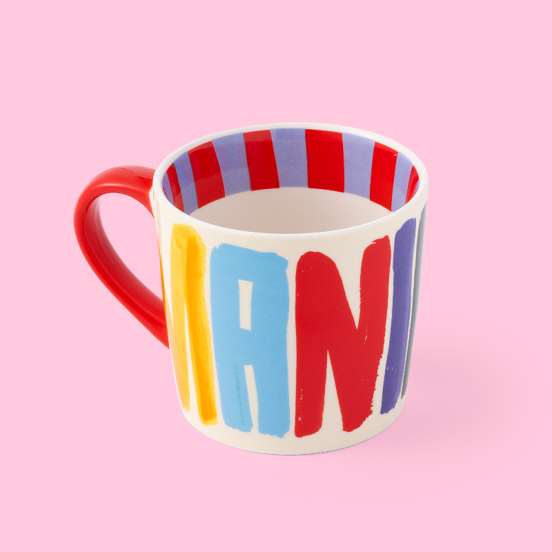 Colourful mug with 'MANIFEST' on a pink background