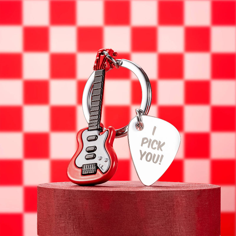 Red guitar-shaped keychain with a silver pick and 'I Pick You!' tag on a red and white checkered background.