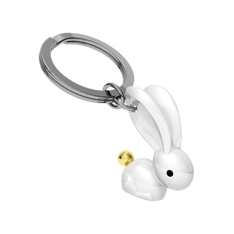 Keychain with a white rabbit design and gold ball on a white background
