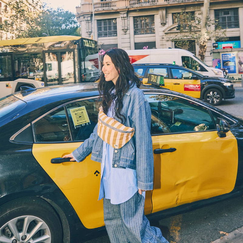 woman wearing striped sling bag