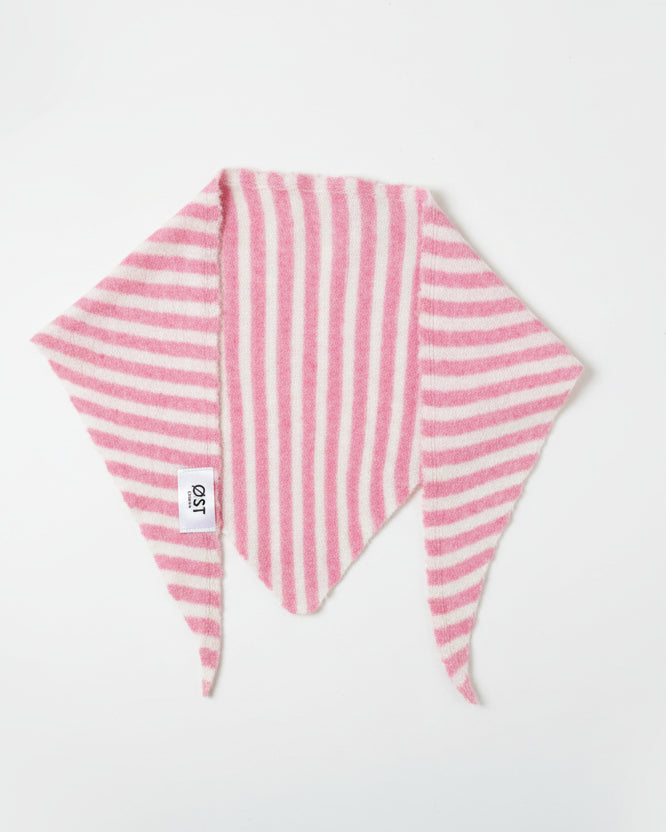 Pink and white striped fabric triangle on a marble surface