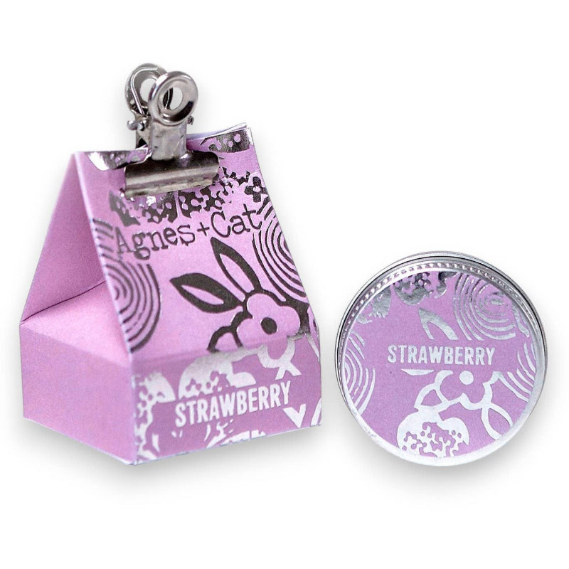 Pink milk carton-shaped container with a strawberry-themed design and 'Agnes & Cat' branding.