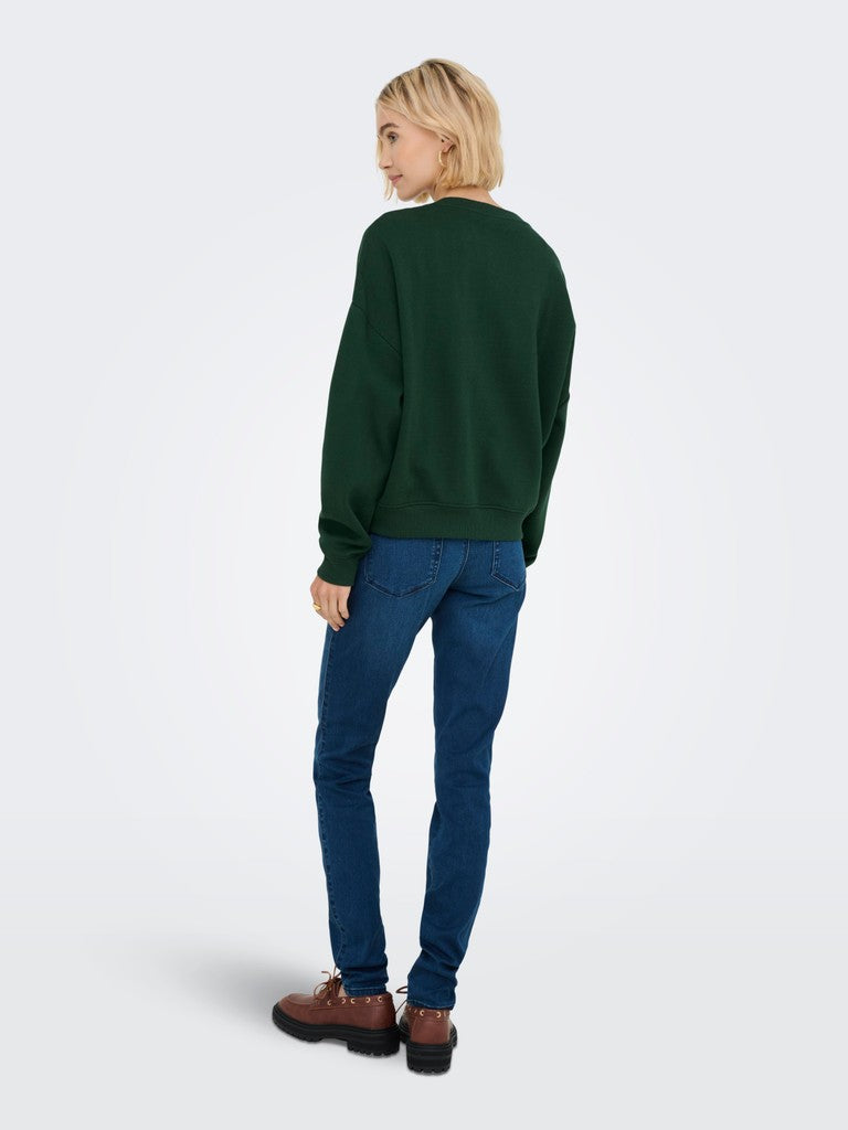 A model shown from the back wearing a dark green crewneck sweatshirt, blue jeans, and brown leather shoes, standing against a light gray studio background.
