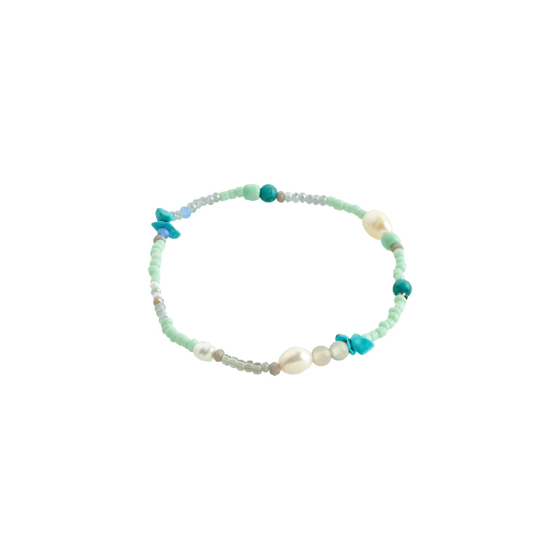 Beaded bracelet with turquoise and white beads on a white background