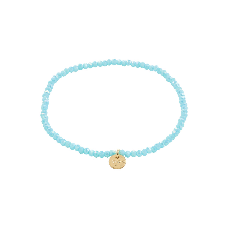 Light blue beaded bracelet with a gold charm on a white background