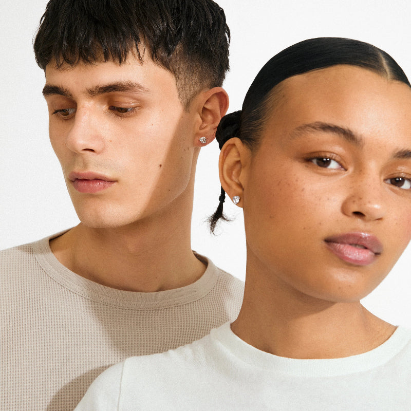 Two people side by side with a plain background