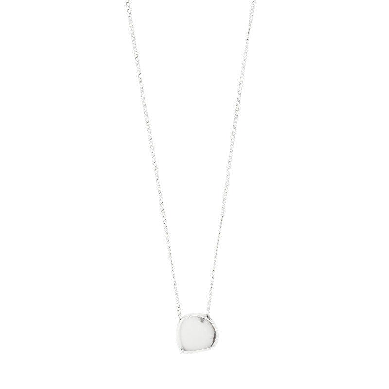 A delicate silver chain necklace with a small, polished, irregularly shaped silver pendant, shown against a plain white background.