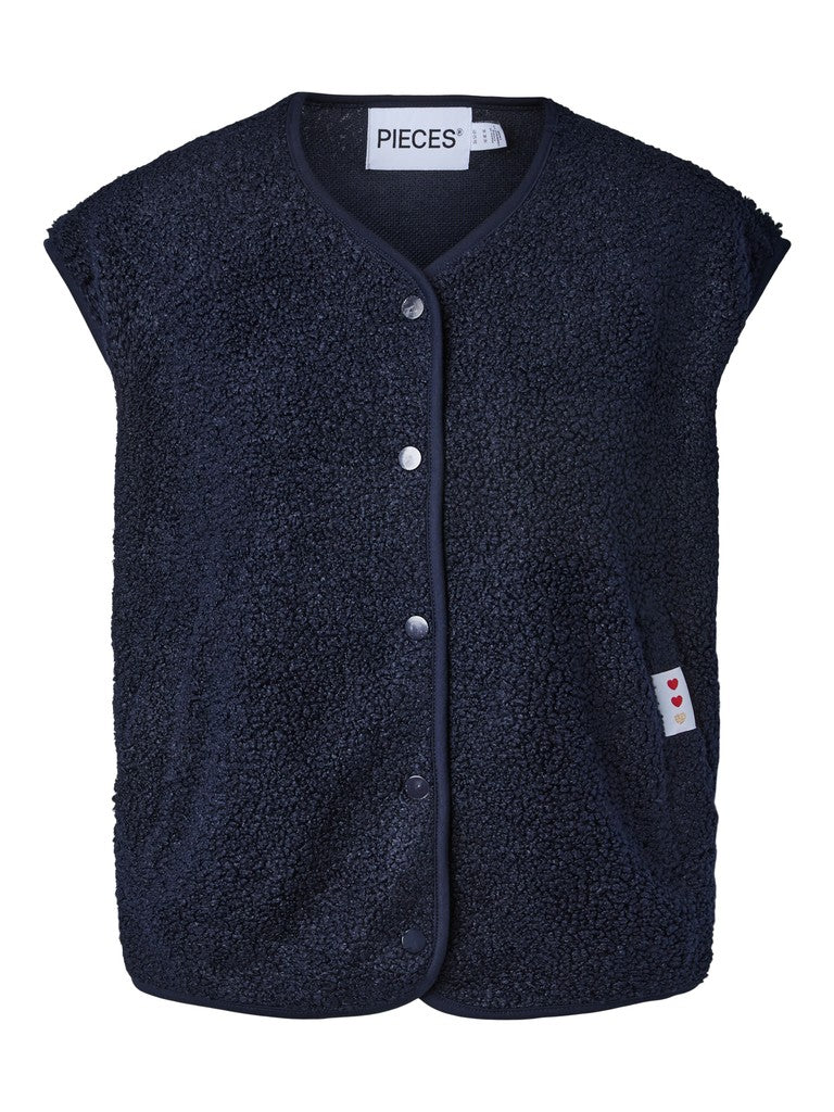A navy blue sherpa fleece vest with a snap-button front closure and a small white brand tag on the side pocket, shown against a plain white background.