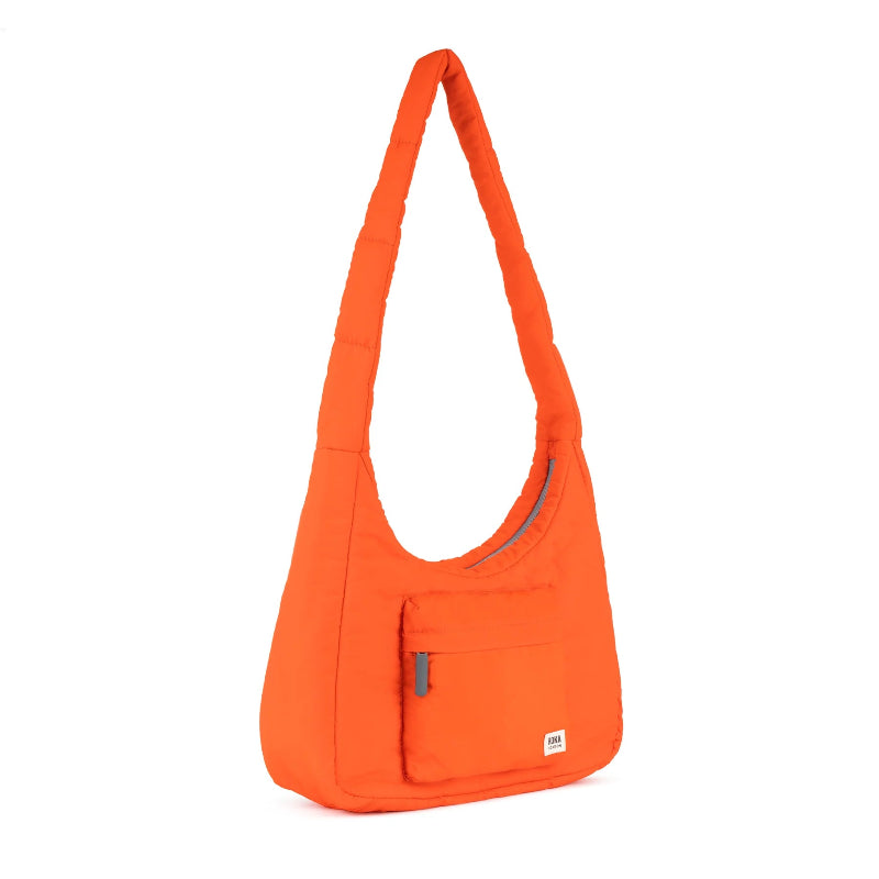 Roka Belize Medium Crossbody Bag Tangerine with a pocket on a white background