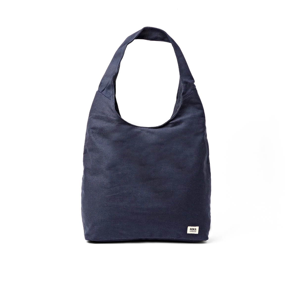 A navy blue canvas hobo-style shoulder bag with a small white rectangular brand tag on the lower right corner, shown against a plain white background.