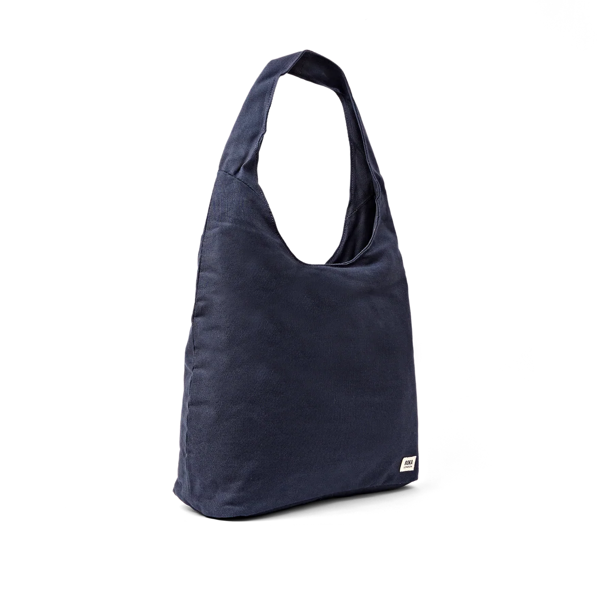 A navy blue canvas hobo-style shoulder bag with a small white brand tag on the lower right corner, shown against a plain white background.