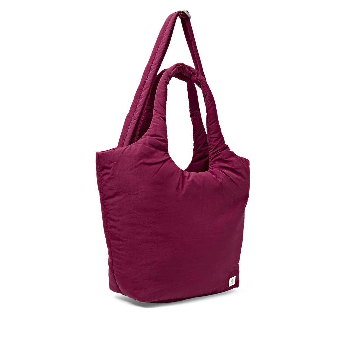 A plum-colored puffy shoulder bag with thick handles and a small white brand tag on the bottom right, shown on a plain white background.